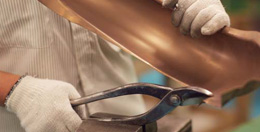 Craftsman making a tuba
